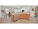 Open kitchen with dining area featuring stainless steel appliances and light wood cabinets at 7908 House Sparrow St, North Las Vegas, NV 89084