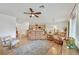 Open-concept living room, hardwood floors, and views into the dining and kitchen areas at 7908 House Sparrow St, North Las Vegas, NV 89084