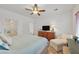 Spacious main bedroom featuring a ceiling fan, dresser, and large window at 7908 House Sparrow St, North Las Vegas, NV 89084