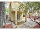View of covered patio and landscaped backyard with trees, fence, and red rock ground cover at 8113 Bay Springs Dr, Las Vegas, NV 89128