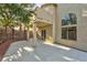 Expansive backyard with covered patio, stucco walls, and an arched window detail on the upper level at 8113 Bay Springs Dr, Las Vegas, NV 89128