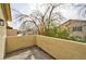 View from the balcony showing the outdoor space, stucco wall, and view of the neighborhood at 8113 Bay Springs Dr, Las Vegas, NV 89128