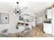 Bright kitchen featuring a large island with seating, modern lighting, and stainless steel appliances at 8113 Bay Springs Dr, Las Vegas, NV 89128
