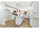Bright kitchen with a center island, white cabinets, marble countertops, and modern appliances at 8113 Bay Springs Dr, Las Vegas, NV 89128