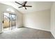 Bedroom with vaulted ceiling, sliding glass door leading to a balcony, and neutral carpeting at 8113 Bay Springs Dr, Las Vegas, NV 89128