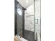 Modern glass shower featuring black hardware, black mosaic tile, and marble accents at 8113 Bay Springs Dr, Las Vegas, NV 89128