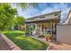 Large grassy backyard features a patio, hot tub, pergola, and a privacy wall with a shed at 8217 Fritzen Ave, Las Vegas, NV 89131