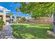 Well-maintained backyard featuring a lush lawn, patio area, and privacy landscaping at 8217 Fritzen Ave, Las Vegas, NV 89131