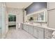 Modern bathroom features a double vanity, walk-in closet, decorative mirror, and luxury finishes at 8217 Fritzen Ave, Las Vegas, NV 89131