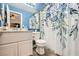 Stylish bathroom showcasing blue accents, a floral shower curtain, and a marble-look vanity at 8217 Fritzen Ave, Las Vegas, NV 89131
