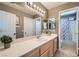 Bright bathroom features a mirrored vanity, modern lighting, and a shower-tub combo at 8217 Fritzen Ave, Las Vegas, NV 89131