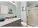 Stylish bathroom with a gray vanity, modern fixtures, a walk-in shower, and soft blue walls at 8217 Fritzen Ave, Las Vegas, NV 89131