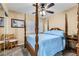 Cozy bedroom features a four-poster bed, neutral walls, carpet floors, and a ceiling fan at 8217 Fritzen Ave, Las Vegas, NV 89131