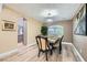 Elegant dining room featuring a chandelier, wood floors, and a view into the kitchen at 8217 Fritzen Ave, Las Vegas, NV 89131