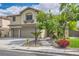 Charming home with a two-car garage, lush landscaping, and a welcoming walkway leading to the front door at 8217 Fritzen Ave, Las Vegas, NV 89131