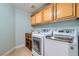 Well-equipped laundry room featuring front-load washer and dryer, with overhead cabinet storage at 8217 Fritzen Ave, Las Vegas, NV 89131