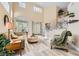 Bright living room with wood floors, high ceilings, and a curved staircase showcasing an elegant and inviting space at 8217 Fritzen Ave, Las Vegas, NV 89131