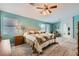 Spacious main bedroom with green walls, carpet floors, a ceiling fan, and a sitting area by the window at 8217 Fritzen Ave, Las Vegas, NV 89131