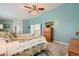 A neutral carpeted main bedroom features a ceiling fan and traditional wooden dresser at 8217 Fritzen Ave, Las Vegas, NV 89131