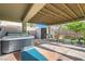 This patio features a spa, a storage shed, outdoor seating and a covered patio area with a wood-look ceiling at 8217 Fritzen Ave, Las Vegas, NV 89131