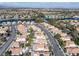 Scenic aerial view of the community with lush landscaping, mature trees, and nearby lake access at 8228 Lauderdale Ct, Las Vegas, NV 89128