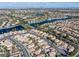 Picturesque aerial view showcasing a community with lakes, well-maintained homes, and a cityscape in the distance at 8228 Lauderdale Ct, Las Vegas, NV 89128