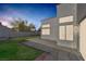 Serene backyard with a well-kept lawn, stone pavers, and privacy fence for a cozy outdoor space at 8228 Lauderdale Ct, Las Vegas, NV 89128