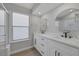 Stylish bathroom featuring double sinks, white cabinets, and a glass-enclosed shower at 8228 Lauderdale Ct, Las Vegas, NV 89128