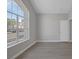 A naturally lit room with neutral walls, baseboards, and a large window at 8228 Lauderdale Ct, Las Vegas, NV 89128