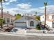 Inviting single-Gathering home with a manicured front yard, charming desert landscaping, and a two-car garage at 8228 Lauderdale Ct, Las Vegas, NV 89128