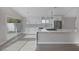 Bright kitchen boasting white cabinets, stainless appliances, and a large quartz island at 8228 Lauderdale Ct, Las Vegas, NV 89128