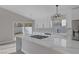 Bright kitchen featuring white cabinetry, quartz countertops, and stainless steel appliances at 8228 Lauderdale Ct, Las Vegas, NV 89128
