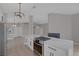 Open kitchen featuring white cabinets, stainless appliances, a quartz island, and open floorplan at 8228 Lauderdale Ct, Las Vegas, NV 89128