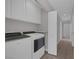 Laundry room featuring modern washer and dryer, storage cabinets, and a folding shelf at 8228 Lauderdale Ct, Las Vegas, NV 89128