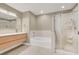 Large primary bathroom with a soaking tub, walk-in shower, sleek vanity, and a glass shower door at 8255 Las Vegas Blvd # 1422, Las Vegas, NV 89123