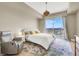 Cozy bedroom featuring a queen-size bed, bedside tables, reading chair, and city views at 8255 Las Vegas Blvd # 1422, Las Vegas, NV 89123