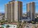 Stunning aerial view of a luxury high-rise condo building with balconies, a pool, and manicured landscaping at 8255 Las Vegas Blvd # 1422, Las Vegas, NV 89123