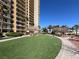 Enjoy the condo's lush green lawn, walkway, and seating near a luxurious high rise building at 8255 Las Vegas Blvd # 1422, Las Vegas, NV 89123