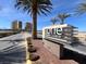 Exterior view of the 'ONE' community signage with palm trees and landscaping at 8255 Las Vegas Blvd # 1422, Las Vegas, NV 89123
