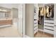 Well-organized walk-in closet with custom shelving, rods, and a view to the bathroom at 8255 Las Vegas Blvd # 1422, Las Vegas, NV 89123