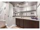 Basement bar area with a sink, storage cabinets and view of stairs at 905 Possum Hill St, Henderson, NV 89014