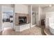 Well-lit bathroom showcasing a glass-enclosed shower, bathtub, and a decorative fireplace at 905 Possum Hill St, Henderson, NV 89014