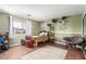 Cozy bedroom with hardwood floors, plants, area rug, and a papasan chair at 905 Possum Hill St, Henderson, NV 89014