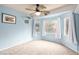 This bedroom has a ceiling fan, light blue walls, and three windows at 905 Possum Hill St, Henderson, NV 89014