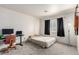 Bedroom with neutral carpet, a desk, a black-out curtain, and a floor lamp at 905 Possum Hill St, Henderson, NV 89014