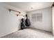 Empty bedroom with neutral carpet, and two black instrument cases standing against the wall at 905 Possum Hill St, Henderson, NV 89014