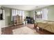 Bedroom featuring hardwood floors, ample natural light, a bed, and storage shelving at 905 Possum Hill St, Henderson, NV 89014