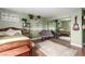 Green bedroom with a full-length mirror, hardwood floors, and a guitar on the wall at 905 Possum Hill St, Henderson, NV 89014