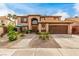 Charming two-story home featuring a tile roof, front yard landscaping and an attached two car garage at 905 Possum Hill St, Henderson, NV 89014
