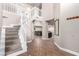 A grand foyer featuring tile floors, soaring ceilings, staircase, and lots of natural light at 905 Possum Hill St, Henderson, NV 89014